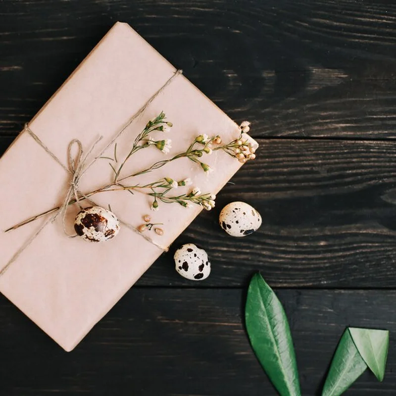 Prezent w papierze rzemieślniczym z jajami przepiórczymi i gałązkami wierzby